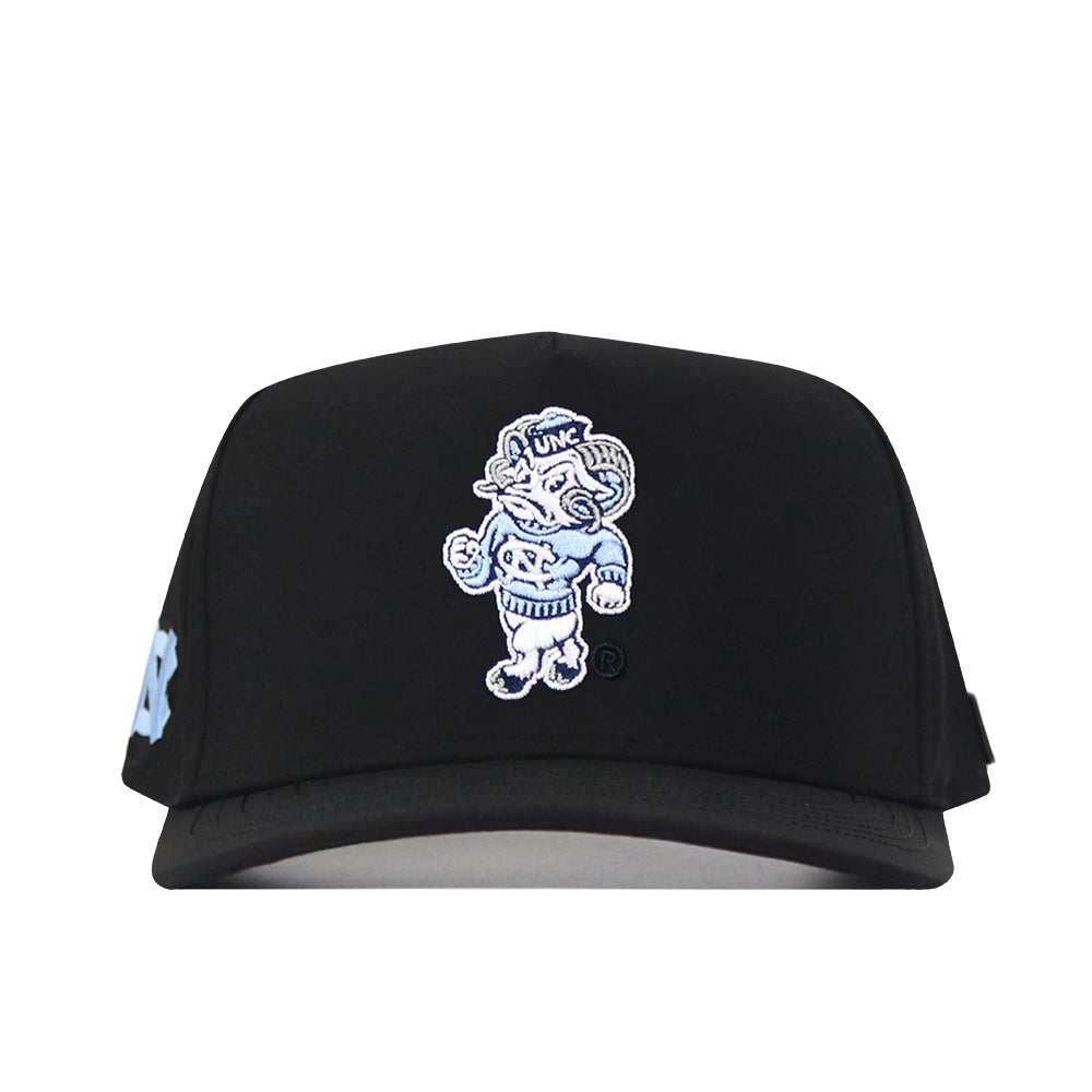 Show your UNC pride with the North Carolina Tar Heels Mascot Hat - Black by No Rivals, featuring high-performance black fabric and an embroidered cartoon ram mascot sporting a UNC sweater on the front. This stylish snapback cap is the perfect way to represent the University of North Carolina.
