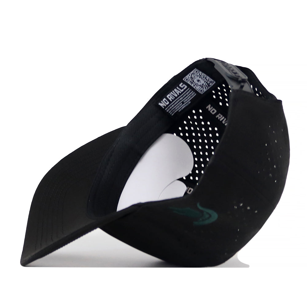 The Michigan State Spartans Football Mascot Hat by No Rivals is displayed upside down, revealing its interior labels and perforated back panels. The underbill is visible, along with a curved paper insert that maintains the hat’s shape. Crafted from performance fabric and equipped with a convenient snap back closure, this black cap ensures both comfort and an adjustable fit.