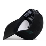 The Michigan State Spartans Football Mascot Hat by No Rivals is displayed upside down, revealing its interior labels and perforated back panels. The underbill is visible, along with a curved paper insert that maintains the hat’s shape. Crafted from performance fabric and equipped with a convenient snap back closure, this black cap ensures both comfort and an adjustable fit.