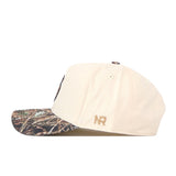 A side view of the No Rivals Minnesota Gophers Camo Connector Hat, showcasing a beige crown with a camouflage-patterned brim, gold NR initials embroidered above the ear area, and an adjustable snap back for the perfect fit.