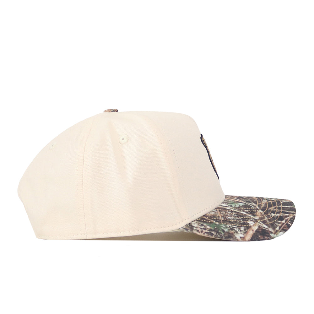 The No Rivals Minnesota Gophers Camo Connector Hat is a beige baseball cap with a camouflage-patterned brim and an adjustable snap back, pictured from the side.