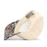 The No Rivals Minnesota Gophers Camo Connector Hat, shown propped on its side, displays the inner label and mesh lining. This beige and camouflage trucker hat features a snapback closure for an adjustable fit, while its brim showcases a forest-inspired pattern.