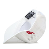 A white Utah Utes Football Mascot Hat by No Rivals is shown from the side and inside, highlighting ventilation holes, a black and white tag reading No Rivals, and red embroidered letters along the outer side. Crafted from performance fabric for enhanced comfort, this cap features an adjustable snap back closure and an embroidered logo that adds a sporty flair.