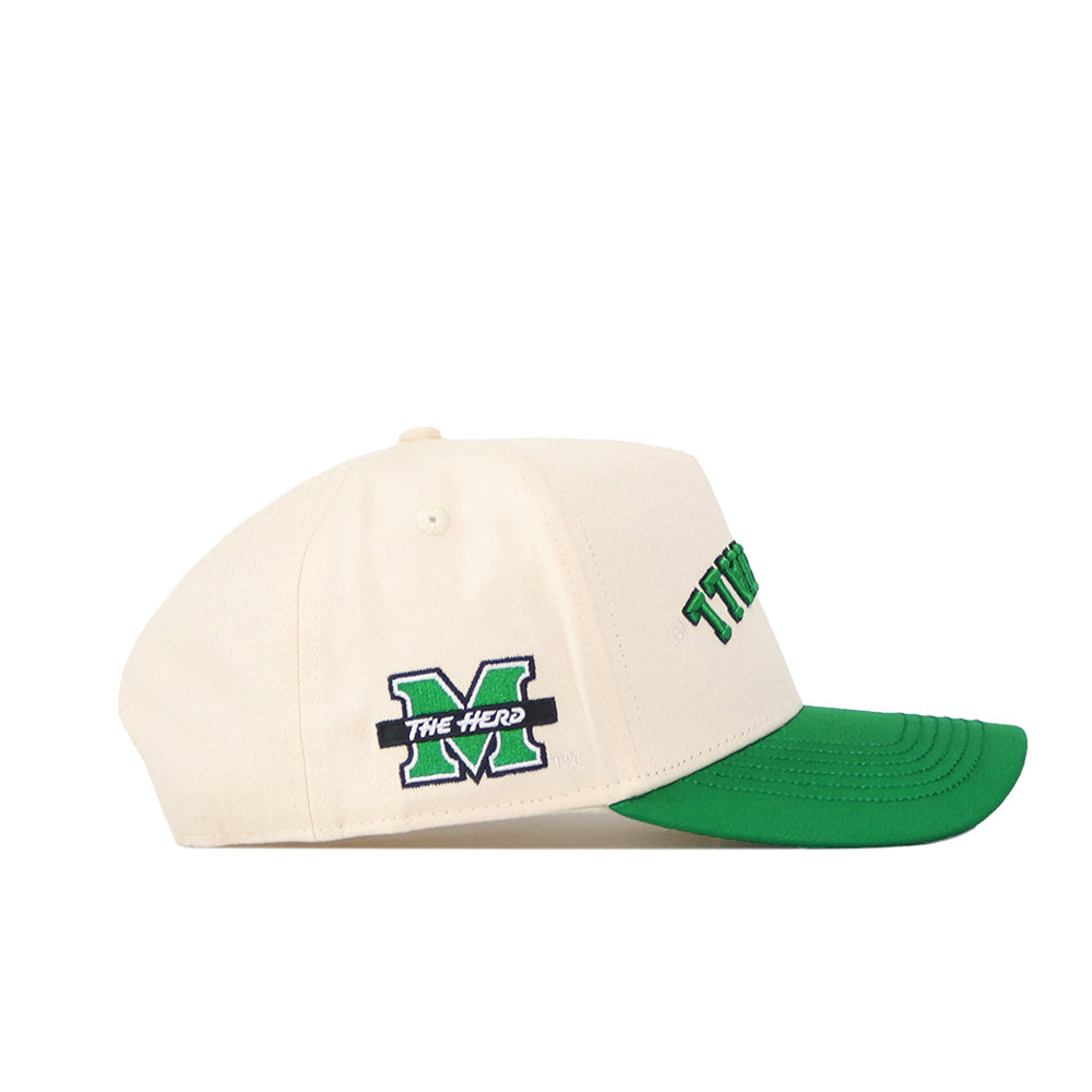 The Upside Down Marshall Hat by No Rivals is a cream snapback baseball cap with a green visor, officially licensed for the Marshall Thundering Herd. It features a green M logo and "The Herd" written in white on the left side, while partial green text on the front adds an extra touch of style.