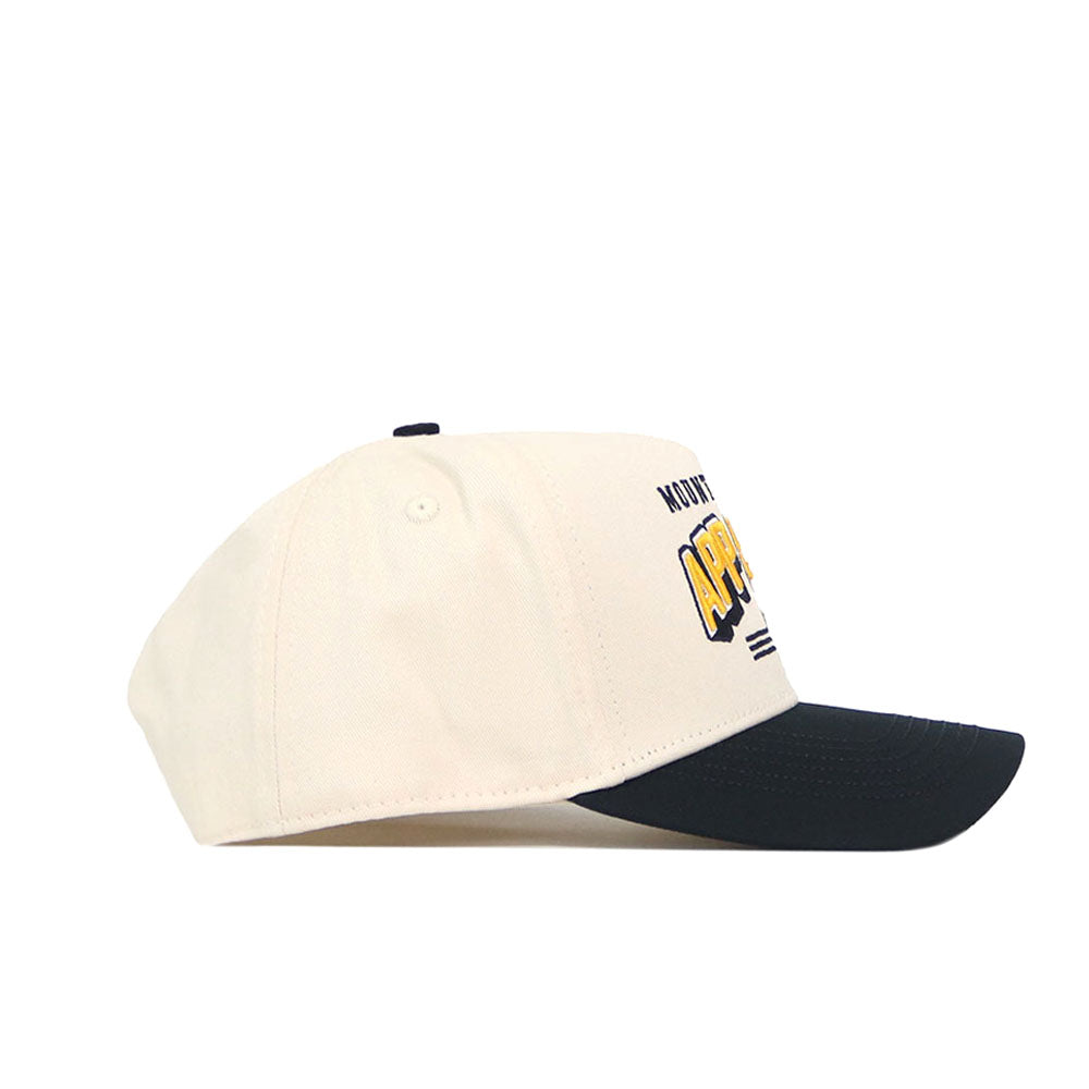The No Rivals App State - Letterman Collection - 2 is a cream snapback hat with a black brim, shown from the side. Yellow and black embroidered logos are partially visible on the front.