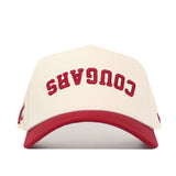 The No Rivals Upside Down Cougars Hat - Washington State features a white snapback, red brim, and "COUGARS" embroidered upside down in red; officially licensed for true fans.