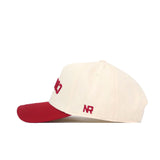 The Upside Down Cougars Hat - Washington State by No Rivals is a cream snapback baseball cap with a red brim and an embroidered NR logo on the side, shown in profile against a white background.