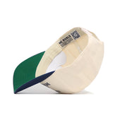 The side view of the App State Mountaineers 250th Americana Hat by No Rivals shows its cream color, green brim with navy edge, visible inner NO RIVALS label, QR code, and embroidered logo.