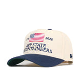 The No Rivals App State Mountaineers 250th Americana Hat is a beige and navy snapback cap with an embroidered American flag, "1776" and "2026," and "App State Mountaineers" on the front. Officially licensed for fans.