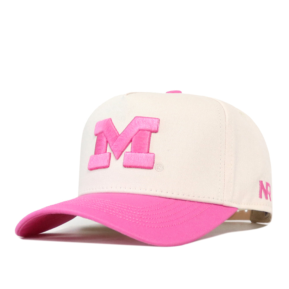 The No Rivals Michigan Pink Out Hat is a white snapback baseball cap featuring a vibrant pink visor and a bold pink letter “M” on the front. A smaller pink logo accents the left side, making this stylish breast cancer support hat perfect for showing your spirit and solidarity.