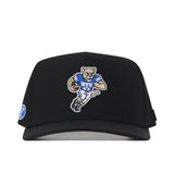 The BYU Cougars Football Mascot Hat by No Rivals features an embroidered cartoon cougar in a BYU jersey holding a football on the front, and a circular BYU logo patch on the left side. This black cap includes a classic snap back closure for adjustable comfort.
