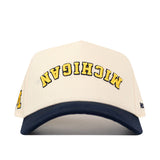 The No Rivals Michigan Wolverines | Upside Down Michigan Hat - Classic features a white cotton design with a navy blue brim, bold yellow MICHIGAN text embroidered upside down on the front, and a classic snap back closure.