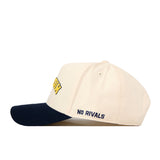 Introducing the Michigan Wolverines | Upside Down Michigan Hat - Classic by No Rivals. This cream-colored baseball cap features a navy blue brim and is crafted from high-quality cotton. The words “NO RIVALS” are embroidered in navy on the side, accompanied by an embroidered logo and an adjustable snapback closure for a perfect fit.