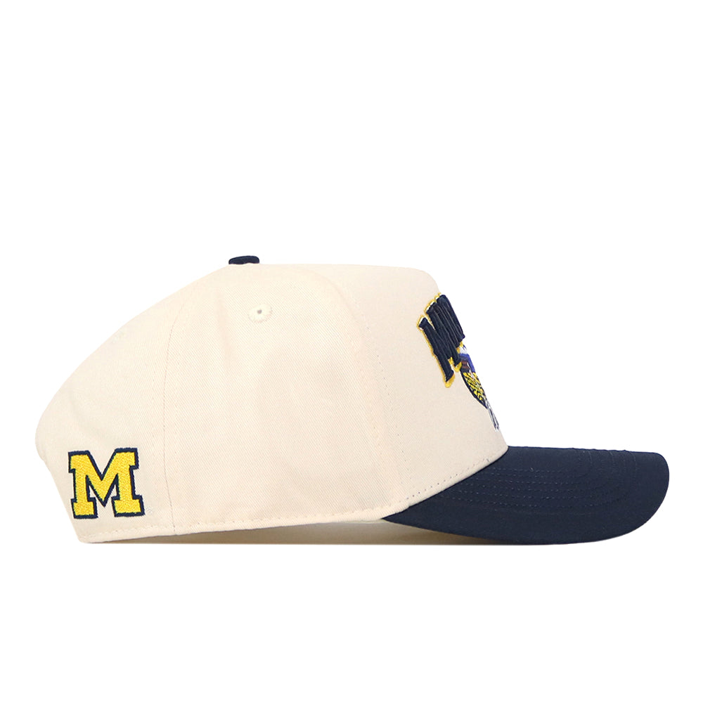Show off your team spirit with the Michigan Wolverines Stadium Hat by No Rivals—a cream-colored cap featuring a navy blue brim and a yellow embroidered M logo on the side. Finished with a classic snap back closure for adjustable comfort, it’s perfect for topping off your gameday outfit.