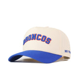 The Right Side Up Broncos Hat - Boise State - Classic by No Rivals is a beige snapback baseball cap featuring an embroidered BRONCOS logo in blue and orange on the front, a blue brim, and "NO RIVALS" text on the right side.