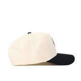 The OSU Pistol Pete Patch Hat - Classic Black by No Rivals features a cream crown, black curved brim, premium cotton construction, and is shown from the side on a white background.