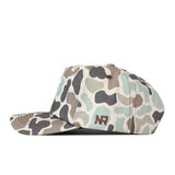 The Indiana Hoosiers Huntsman Hat by No Rivals features a green, tan, and black camouflage pattern with “NR” embroidered in dark thread on the side. Made from high quality cotton, this structured snapback is shown from a side angle.