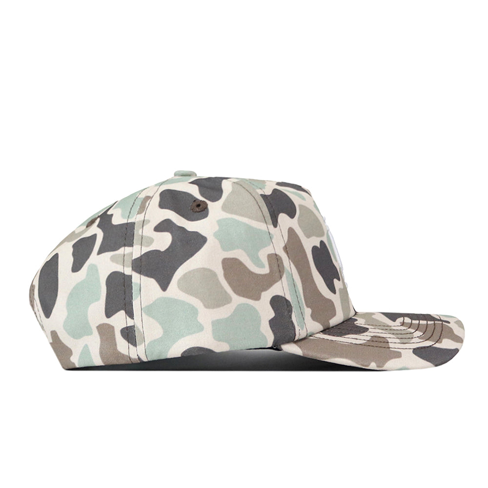A side view of the No Rivals Indiana Hoosiers Huntsman Hat showcases a structured snapback cap with an all-over green, brown, beige, and black camouflage pattern, including the brim. Crafted from high-quality cotton, this hat offers lasting comfort and style.