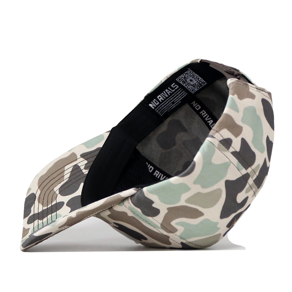 The Indiana Hoosiers Huntsman Hat by No Rivals, featuring a camouflage pattern and crafted from high quality cotton, is flipped upside down to reveal its black inner lining and a label with the No Rivals brand name.