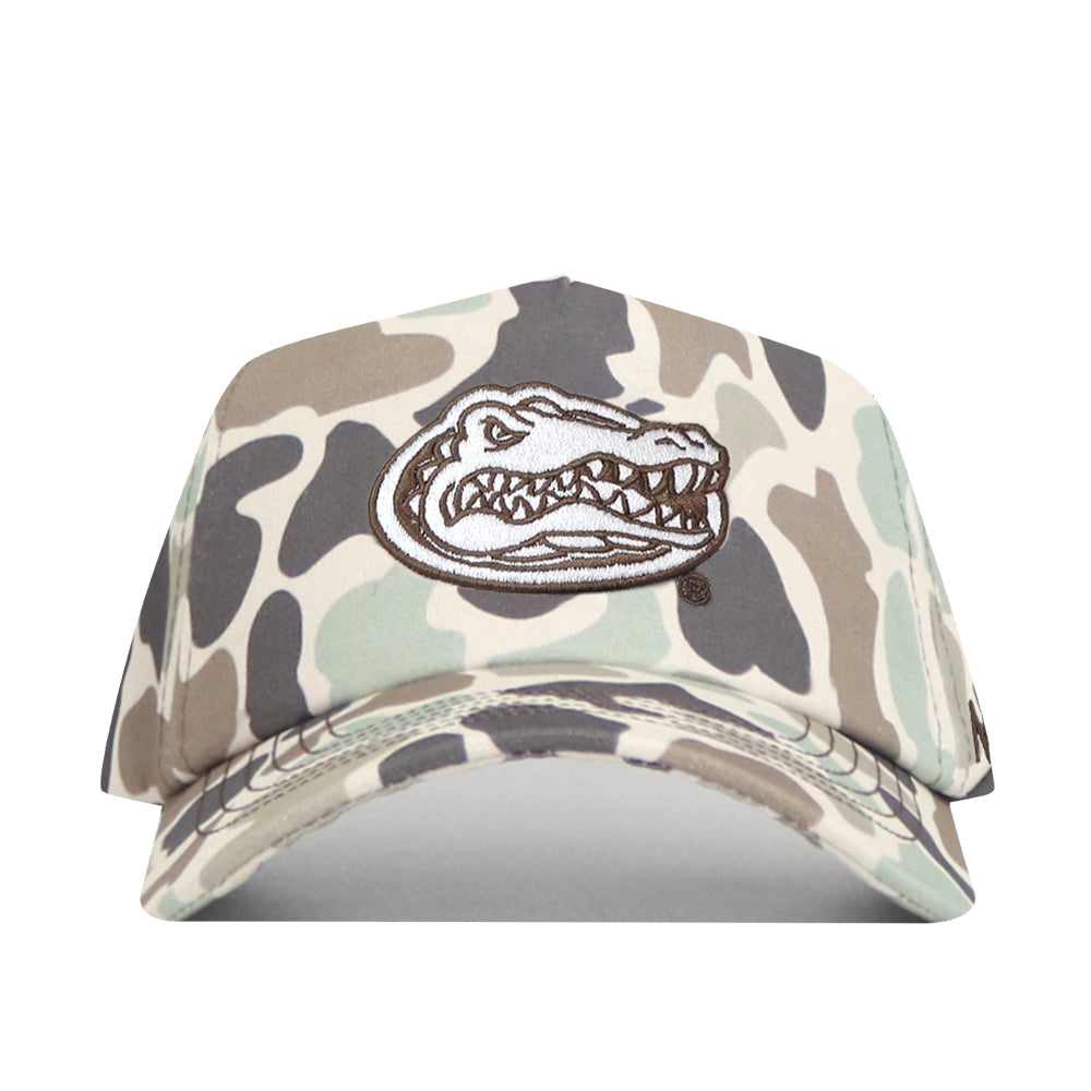 Introducing the Florida Gators Huntsman Hat by No Rivals—a structured snap back cap crafted from premium cotton. This hat features a camouflage pattern in beige, brown, and green tones, and is distinguished by an embroidered alligator head logo on the front. Designed for lasting comfort and style, it’s the perfect accessory for any fan.