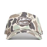 Introducing the Florida Gators Huntsman Hat by No Rivals—a structured snap back cap crafted from premium cotton. This hat features a camouflage pattern in beige, brown, and green tones, and is distinguished by an embroidered alligator head logo on the front. Designed for lasting comfort and style, it’s the perfect accessory for any fan.