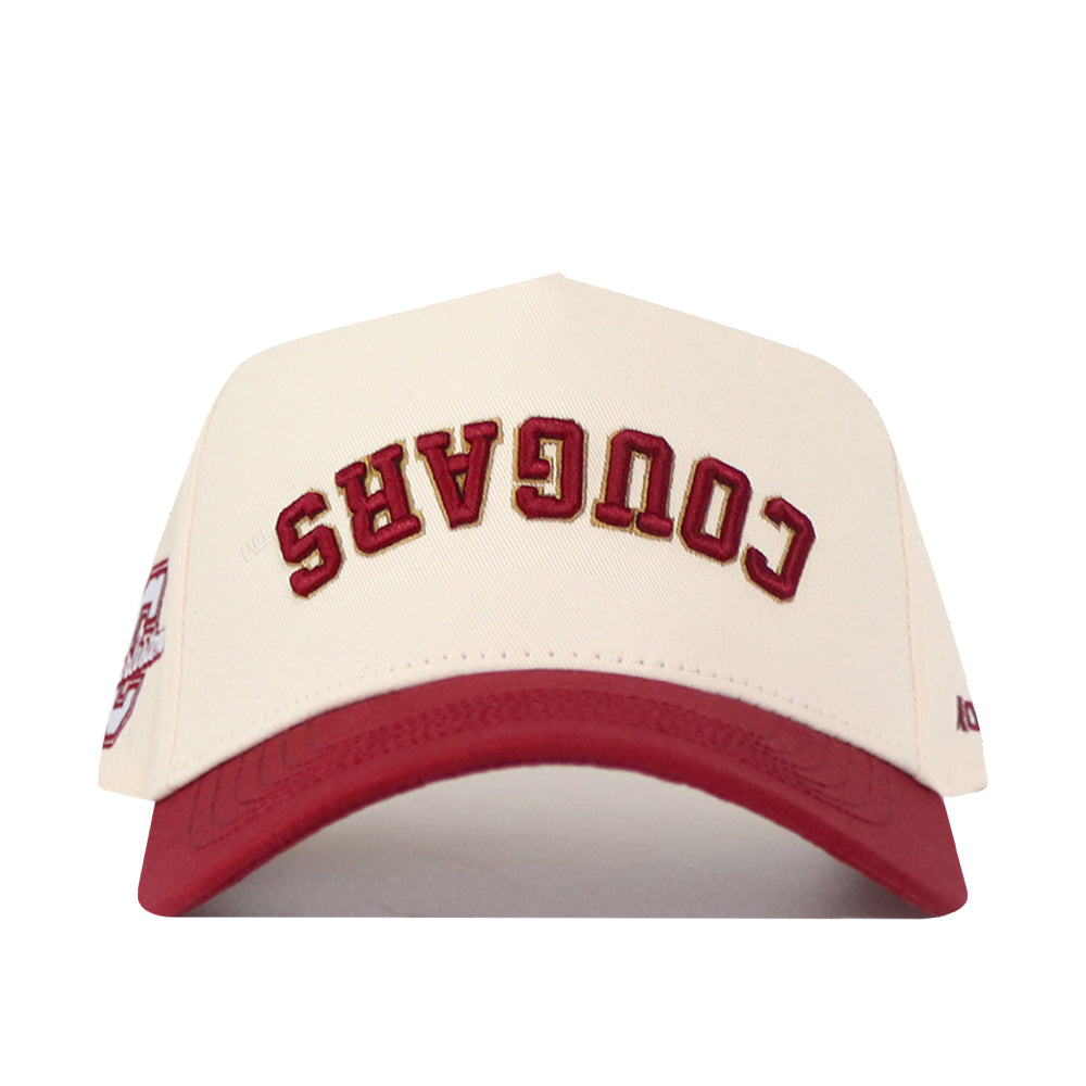 Show your campus pride with the No Rivals College of Charleston | Upside Down Cougars Hat - Classic, a stylish cream and red snapback featuring “COUGARS” embroidered upside down in bold red letters on the front.