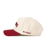 Sure! Here’s a rewritten version using the provided product data: The College of Charleston | Upside Down Cougars Hat - Classic by No Rivals is a cream-colored snapback with a red brim, featuring “NO RIVALS” embroidered in red on the side.