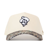 The No Rivals OSU Pistol Pete Camo Hat - Connector Edition is a beige cotton snapback with a cartoon cowboy face logo on the front and a camouflage brim, displayed against a white background.