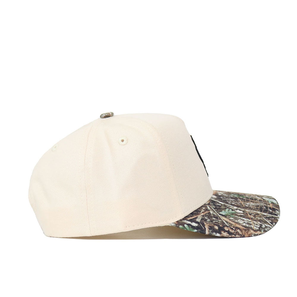 The No Rivals OSU Pistol Pete Camo Hat - Connector Edition is a beige snapback made from high-quality cotton, with a camouflage brim, shown from the side on a white background.
