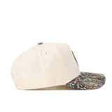The No Rivals OSU Pistol Pete Camo Hat - Connector Edition is a beige snapback made from high-quality cotton, with a camouflage brim, shown from the side on a white background.