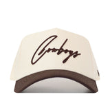 The No Rivals Cowboys Script Espresso Hat (B2B) features a cream color, brown script "Cowboys" on front, a matching brown curved brim, and high-quality cotton construction—perfect for gameday style.