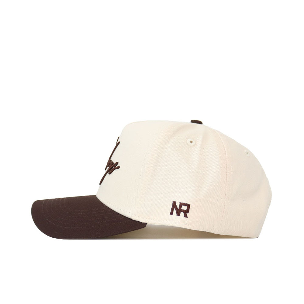 The No Rivals Cowboys Script Espresso Hat (B2B) features a cream snapback design with a dark brown brim and NR letters embroidered in brown—crafted from high-quality cotton for the perfect gameday look.