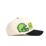 The No Rivals Oregon Alma Mater Hat is a white snapback with a black brim, featuring an embroidered green football helmet and "DUCKS" in bold yellow and green lettering on the side.