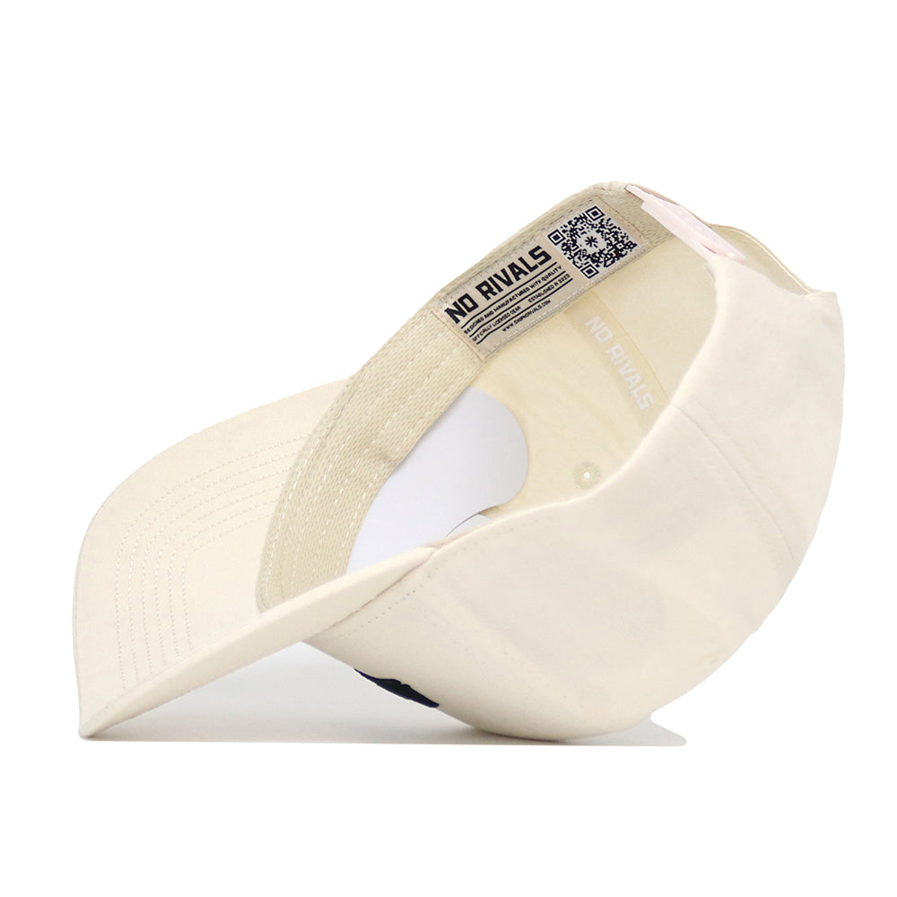 A cream-colored App State Sideline Hat by No Rivals is shown upside down, revealing the interior label with "NO RIVALS" and a QR code. The structured brim and adjustable snapback strap are also visible.