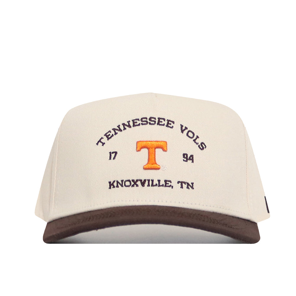 The No Rivals Tennessee Outlaw Hat - Classic is a beige cotton snapback with a brown brim, featuring "Tennessee Vols," "1794," "Knoxville, TN" in brown embroidery and an orange T logo on the front.