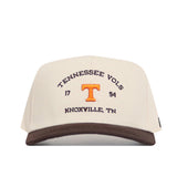The No Rivals Tennessee Outlaw Hat - Classic is a beige cotton snapback with a brown brim, featuring "Tennessee Vols," "1794," "Knoxville, TN" in brown embroidery and an orange T logo on the front.