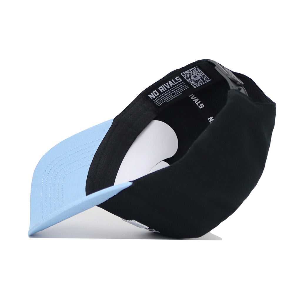 The North Carolina Tailgate Hat by No Rivals is a light blue and black snapback, shown upside down to reveal the inner "NO RIVALS" band, black adjustable strap, and structured high-quality cotton lining.