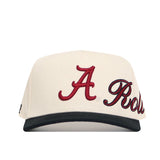 The Alabama Halftime Hat by No Rivals is a structured cream snapback with a black brim, high-quality cotton, a bold red A, and "Roll" embroidered in black and red script on the front.