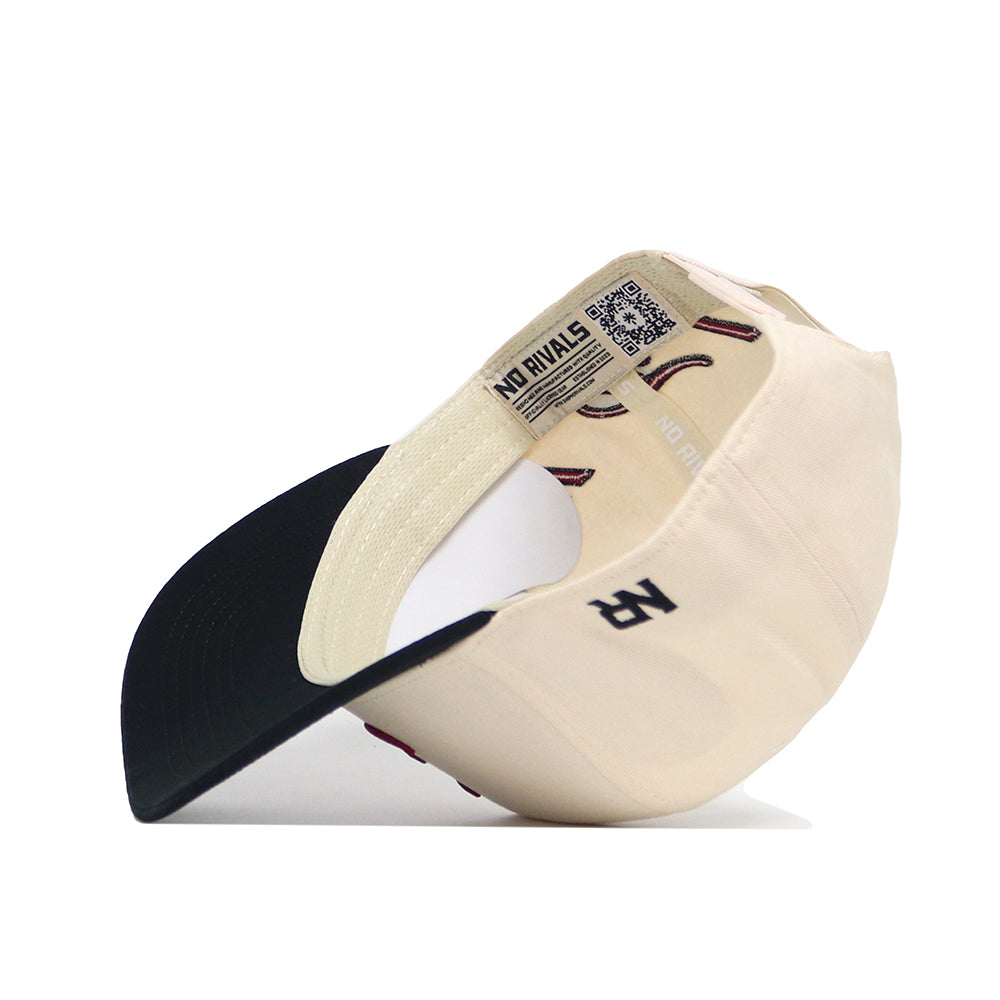 The Alabama Halftime Hat by No Rivals is a cream-colored, structured cotton baseball cap with a black brim. Inside, it features the No Rivals branding and a QR code.