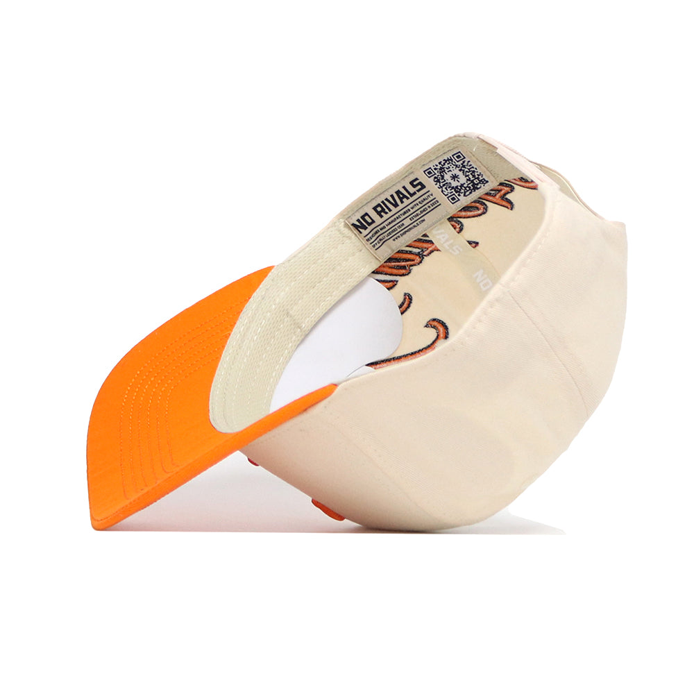 The No Rivals Tennessee Halftime Hat is a cream snapback with an orange brim, shown upside down to reveal its patterned inner lining and QR code label. Crafted from high-quality cotton, it’s set against a white background.