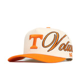 The Tennessee Halftime Hat by No Rivals is a cream and orange snapback with a large orange T, "Volunteers" script on the front and side, an orange brim, and high-quality cotton for a structured fit.