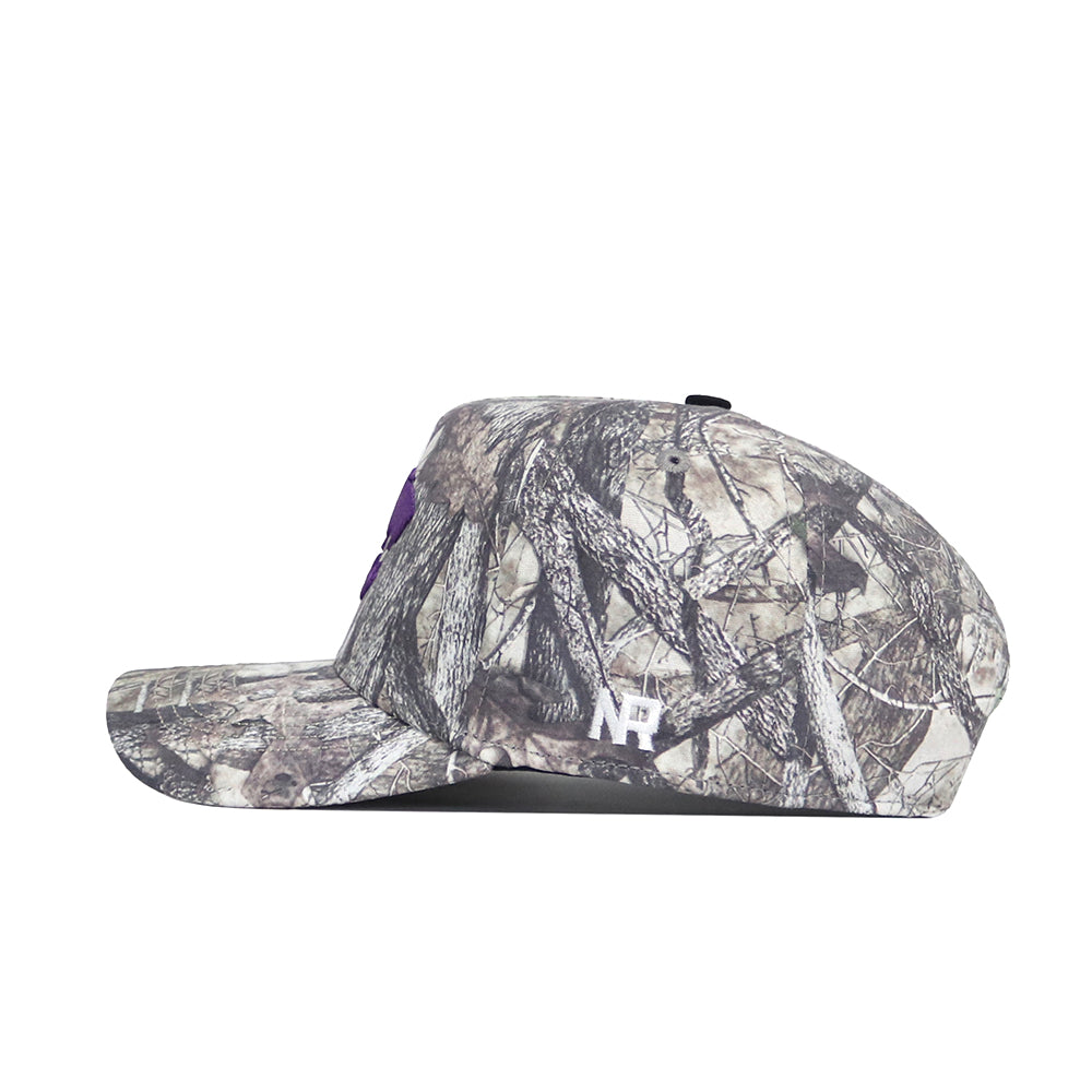 The No Rivals Kansas State Outland Hat is a camouflage-patterned cotton baseball cap with 'NR' embroidered in white on the side, shown in a left profile against a plain white background and featuring a structured fit.