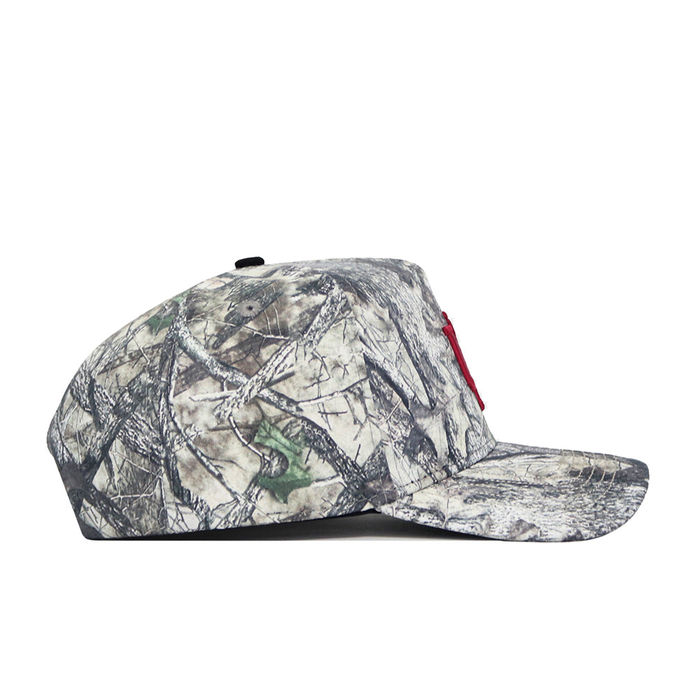 A side view of the No Rivals Indiana Outland Hat, featuring a camouflage snapback design with a flat brim and subtle red front embroidery, made from high-quality cotton and shown against a white background.