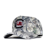 The No Rivals South Carolina Outland Hat features camo print, a large embroidered C with a red gamecock logo on the front, a small white side logo, and a structured fit. Officially licensed for authentic style.