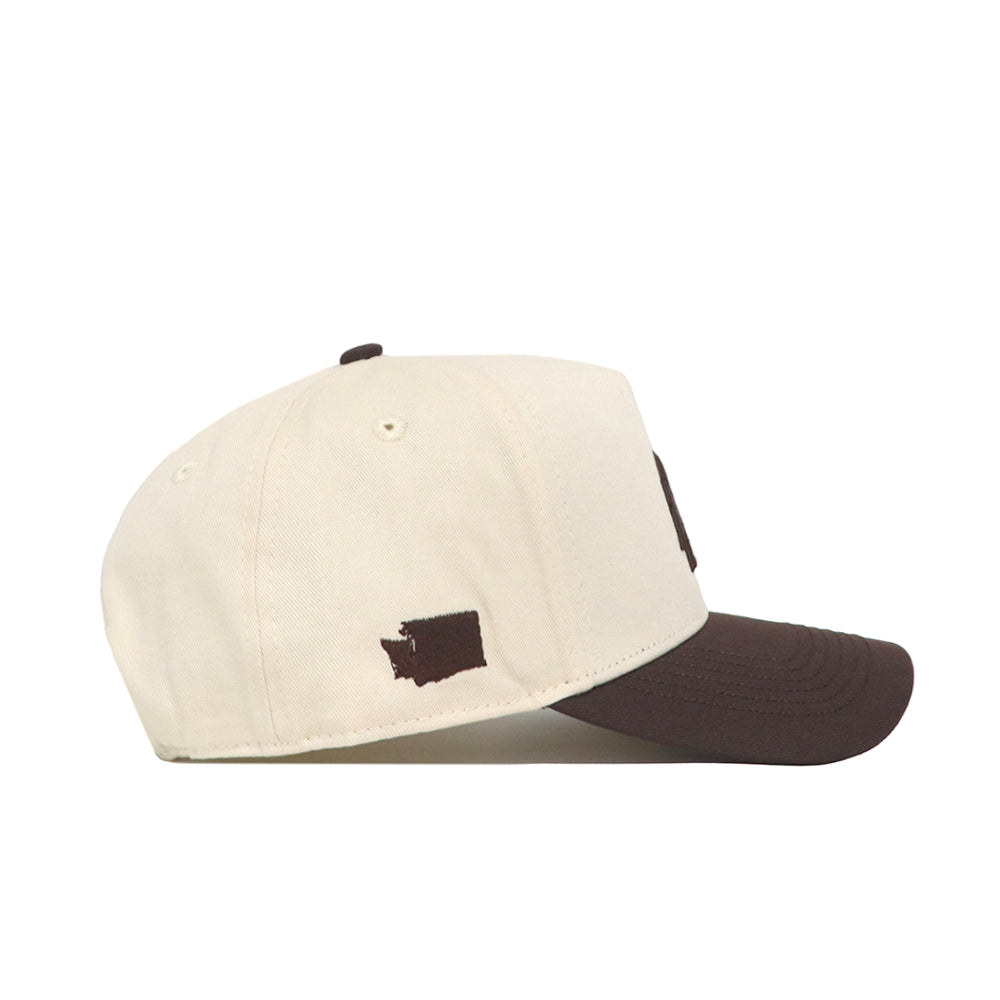 The No Rivals Washington State Espresso Hat is a cream snapback baseball cap with a brown brim and a small brown Washington State silhouette embroidered near the back—perfect for adding classic style to your gameday look.