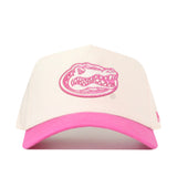 The Florida Pink Out Hat by No Rivals features a white crown, a pink brim, and a pink embroidered alligator logo on the front; this officially licensed snapback cap is both stylish and comfortable.