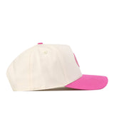 A side view of the No Rivals Florida Pink Out Hat, a snapback baseball cap featuring a white crown, bright pink brim, and matching white button and eyelets. This officially licensed breast cancer hat is displayed against a plain white background.