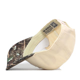 The Wichita State Camo Connector Hat by No Rivals is a beige cotton baseball cap, turned inside out to show its forest camo visor and a fabric NO RIVALS label inside.