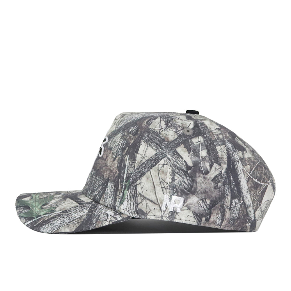 Side view of the Wichita State Outland Hat by No Rivals, featuring a camo pattern, snap back, and white embroidered RP on the side with part of a white B on the front. Plain white background. Perfect for your gameday fit.