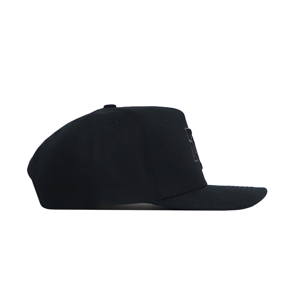 The Texas A&M Night Mode Hat by No Rivals features a black high crown, flat brim, and structured fit, shown from the side with no visible logos or designs on the visible side.